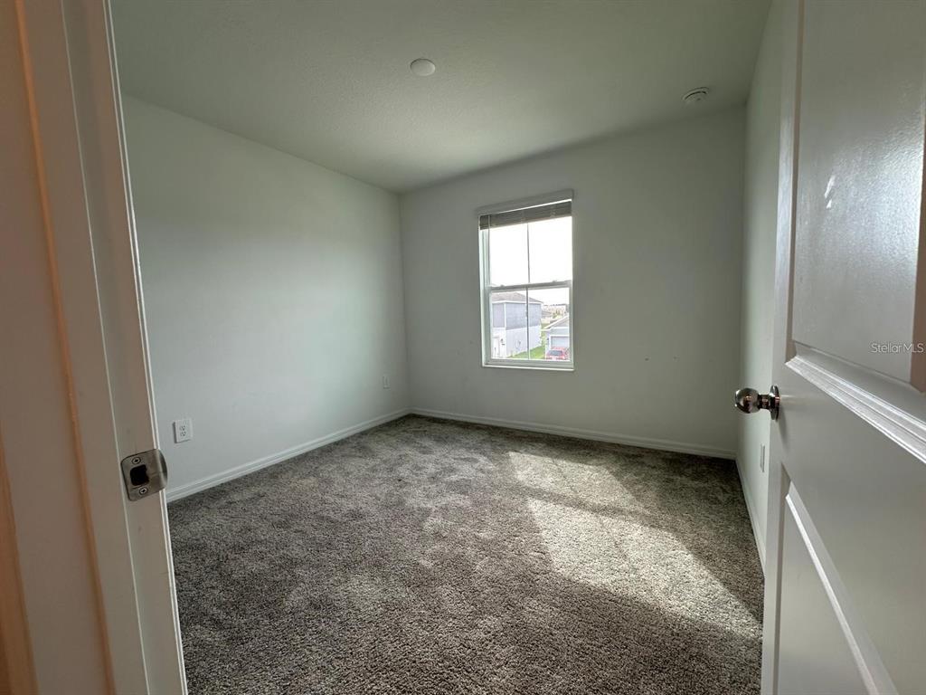 669 Reggie Road Winter Haven, FL 33859 - Photo 17 of 23 an empty room with windows