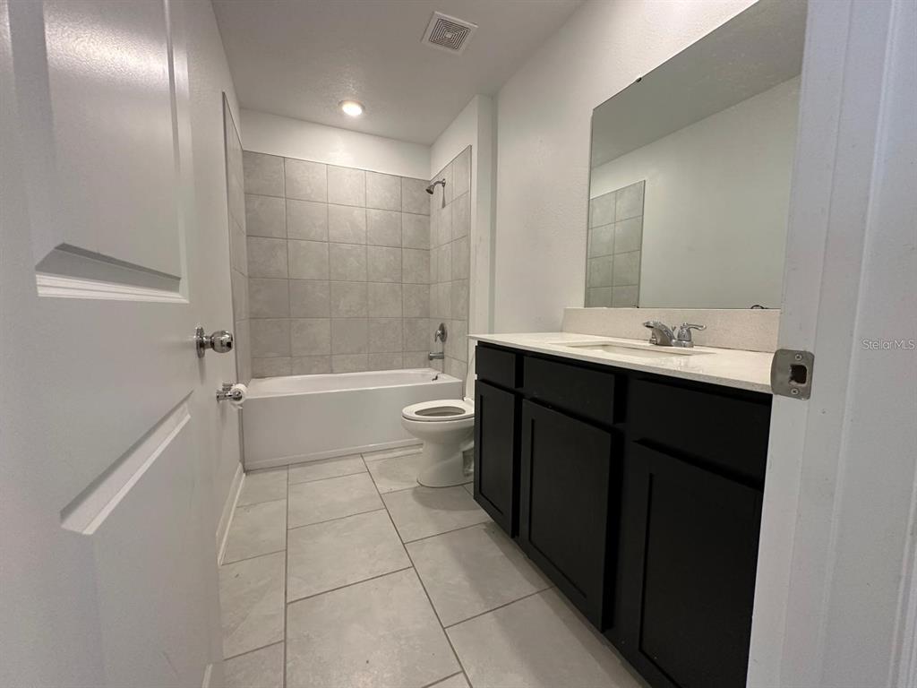 669 Reggie Road Winter Haven, FL 33859 - Photo 19 of 23 a bathroom with a sink a toilet and shower