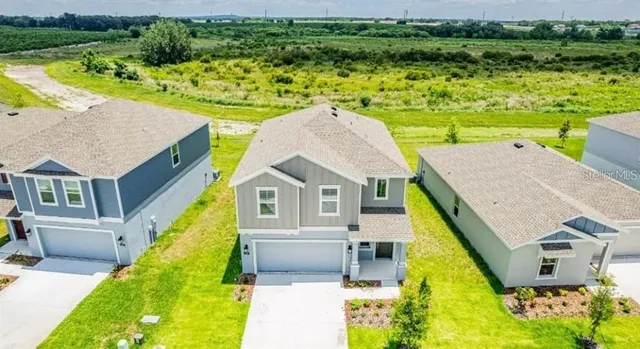 an aerial view of a house with a ocean view