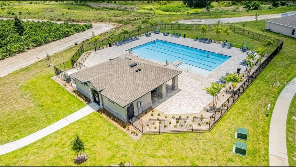 669 Reggie Road Winter Haven, FL 33859 - Photo 22 of 23 a view of a swimming pool with a yard and plants