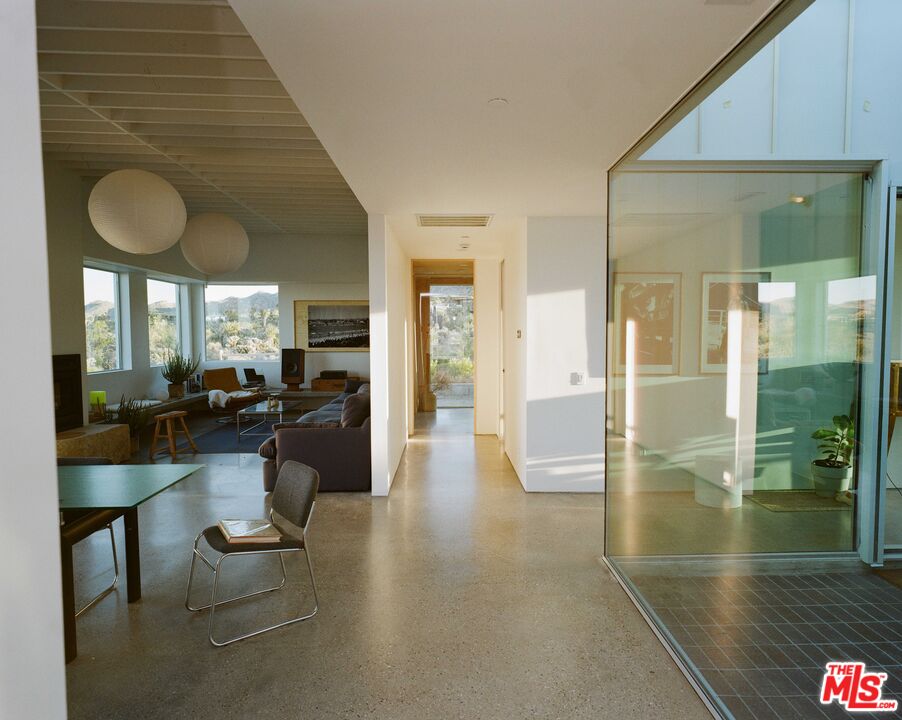 7825 Conejo Avenue Joshua Tree, CA 92252 - Photo 1 of 34 a lobby with furniture and floor to ceiling window