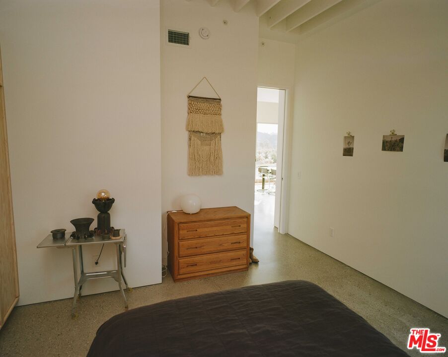 7825 Conejo Avenue Joshua Tree, CA 92252 - Photo 15 of 34 a bedroom with a bed and a couch