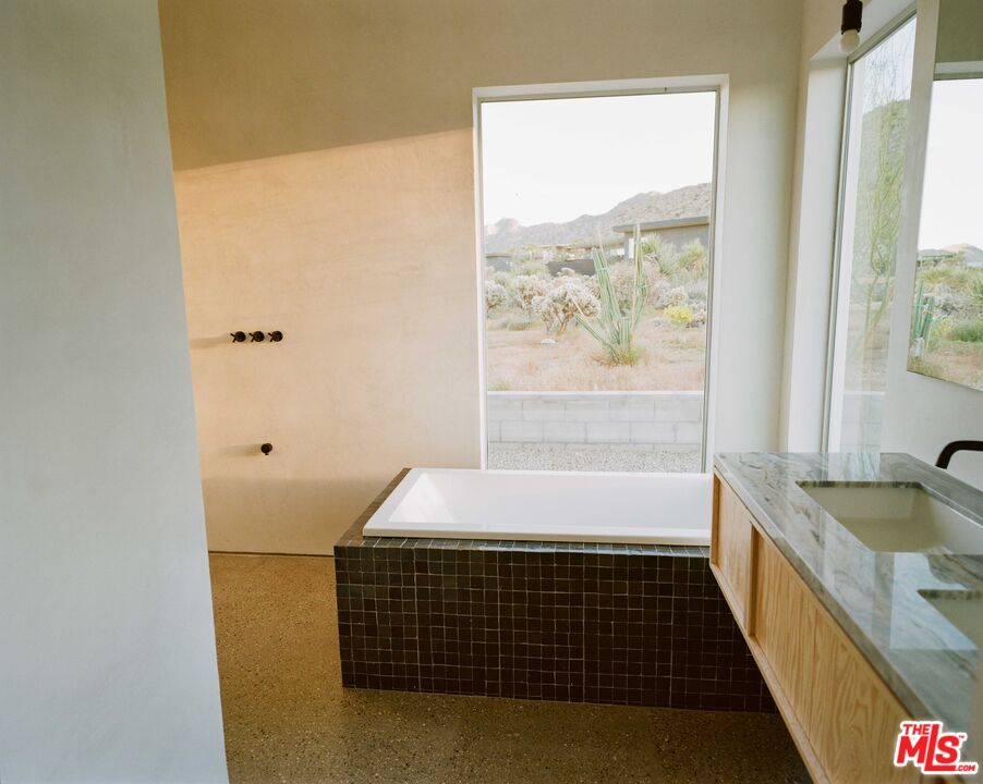 7825 Conejo Avenue Joshua Tree, CA 92252 - Photo 19 of 34 a bedroom with a bed and a window