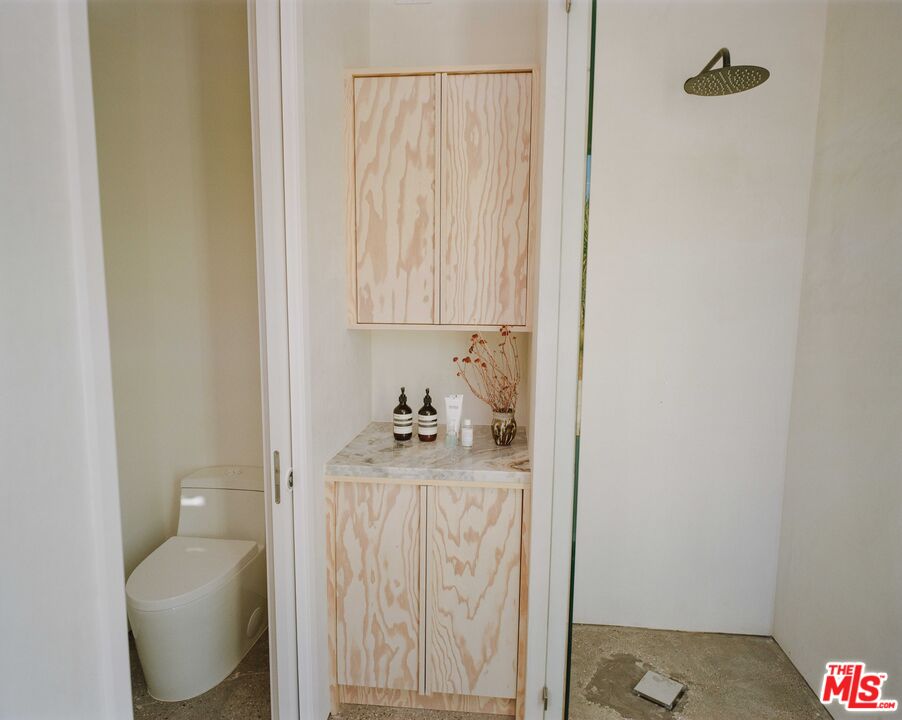 7825 Conejo Avenue Joshua Tree, CA 92252 - Photo 20 of 34 a bathroom with a toilet sink and curtain