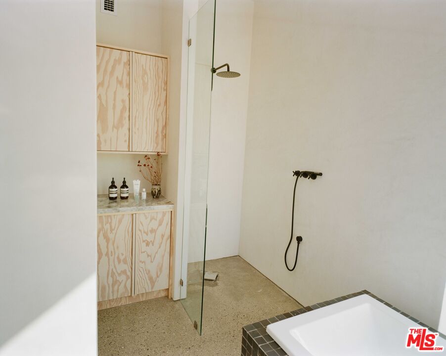 7825 Conejo Avenue Joshua Tree, CA 92252 - Photo 21 of 34 a bathroom with a granite countertop sink and a shower