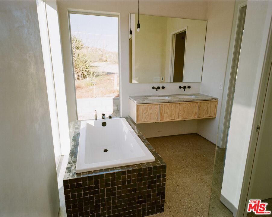 7825 Conejo Avenue Joshua Tree, CA 92252 - Photo 22 of 34 a bathroom with a sink and a mirror