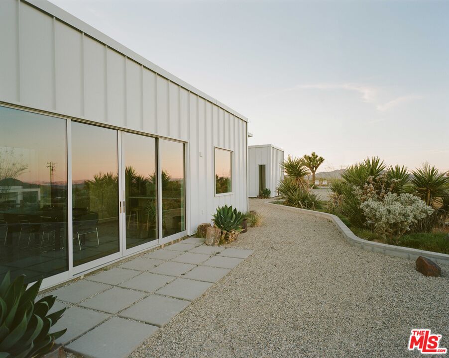 7825 Conejo Avenue Joshua Tree, CA 92252 - Photo 26 of 34 a view of balcony with floor to ceiling window and potted plants