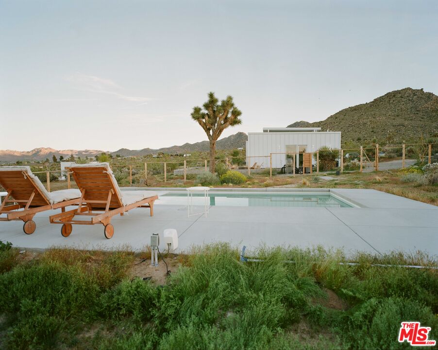 7825 Conejo Avenue Joshua Tree, CA 92252 - Photo 32 of 34 a view of a lake with lawn chairs