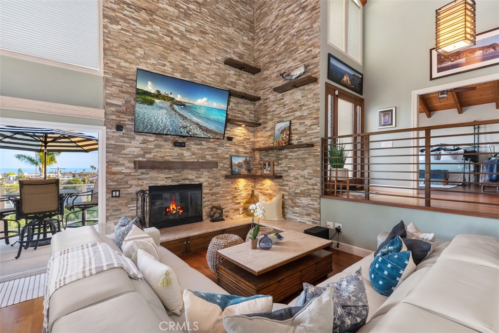 33901 Orilla Road Dana Point, CA 92629 - Photo 22 of 57 a living room with furniture a flat screen tv and a fireplace