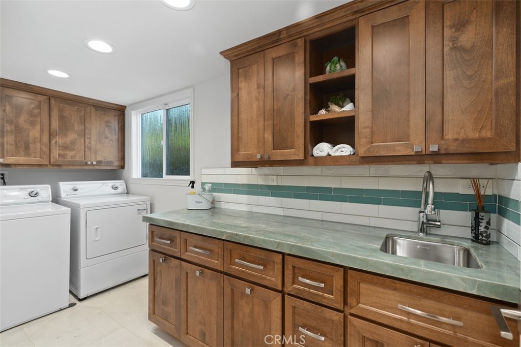 33901 Orilla Road Dana Point, CA 92629 - Photo 37 of 57 large laundry room with custom hardwood cabinets. storage closet with barn door and built in cabinets and drawers
