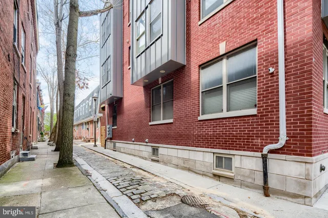 a brick building with a bench in front of it