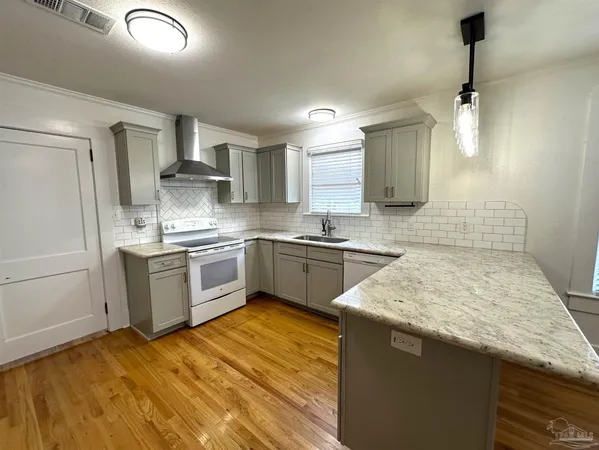 a kitchen with a sink stove and refrigerator