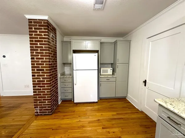 a view of kitchen and empty room