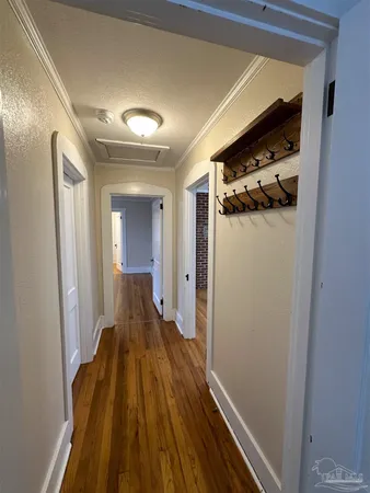 a view of a hallway with wooden floor and staircase