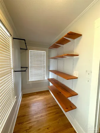 a view of a room with wooden floor and a window