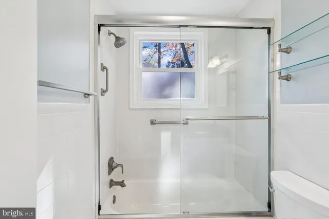 a bathroom with a shower and a sink