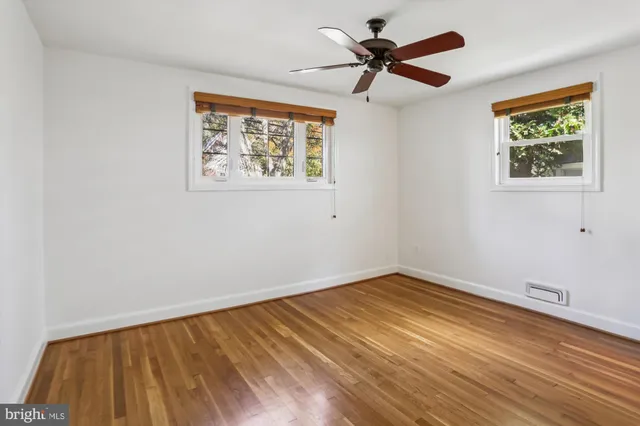 a view of empty room with wooden floor