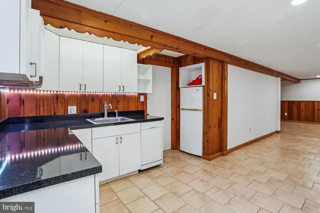 a kitchen with stainless steel appliances granite countertop a sink and cabinets