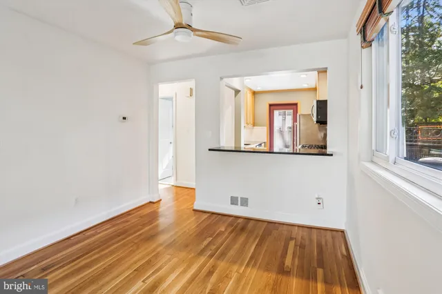 a view of a room with wooden floor and a window