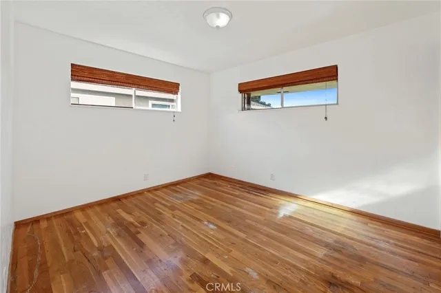 a view of a livingroom with furniture window and a kitchen