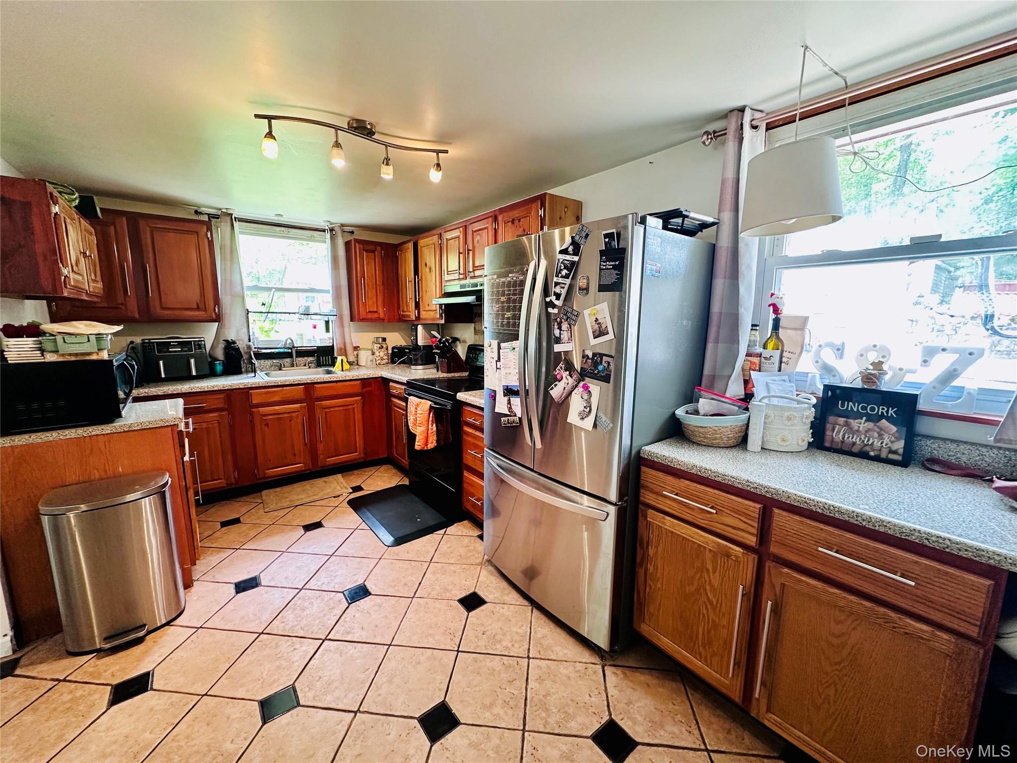 15 Pops Road Cortlandt Manor, NY 10567 - Photo 8 of 14 a kitchen with stainless steel appliances granite countertop a sink counter space cabinets and a window