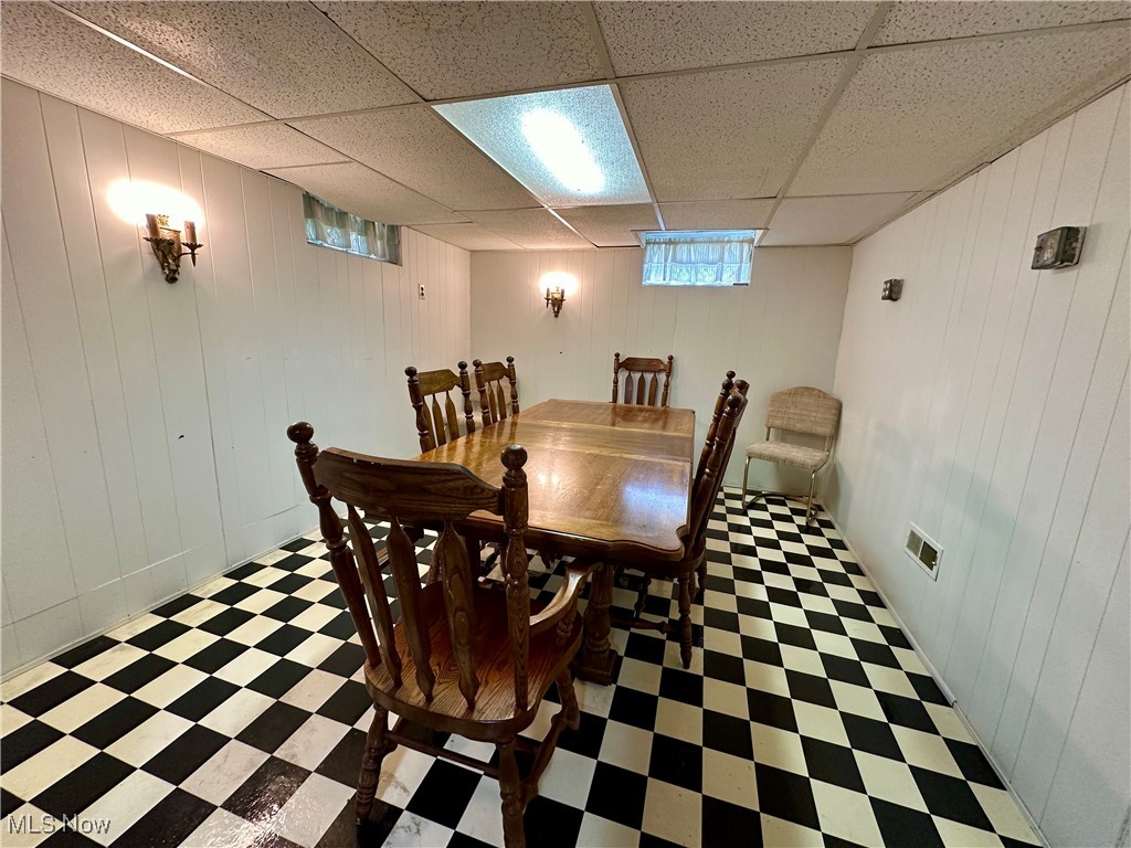 343 Raleigh Avenue Weirton, WV 26062 - Photo 26 of 46 Dining area featuring wood walls and a drop ceiling