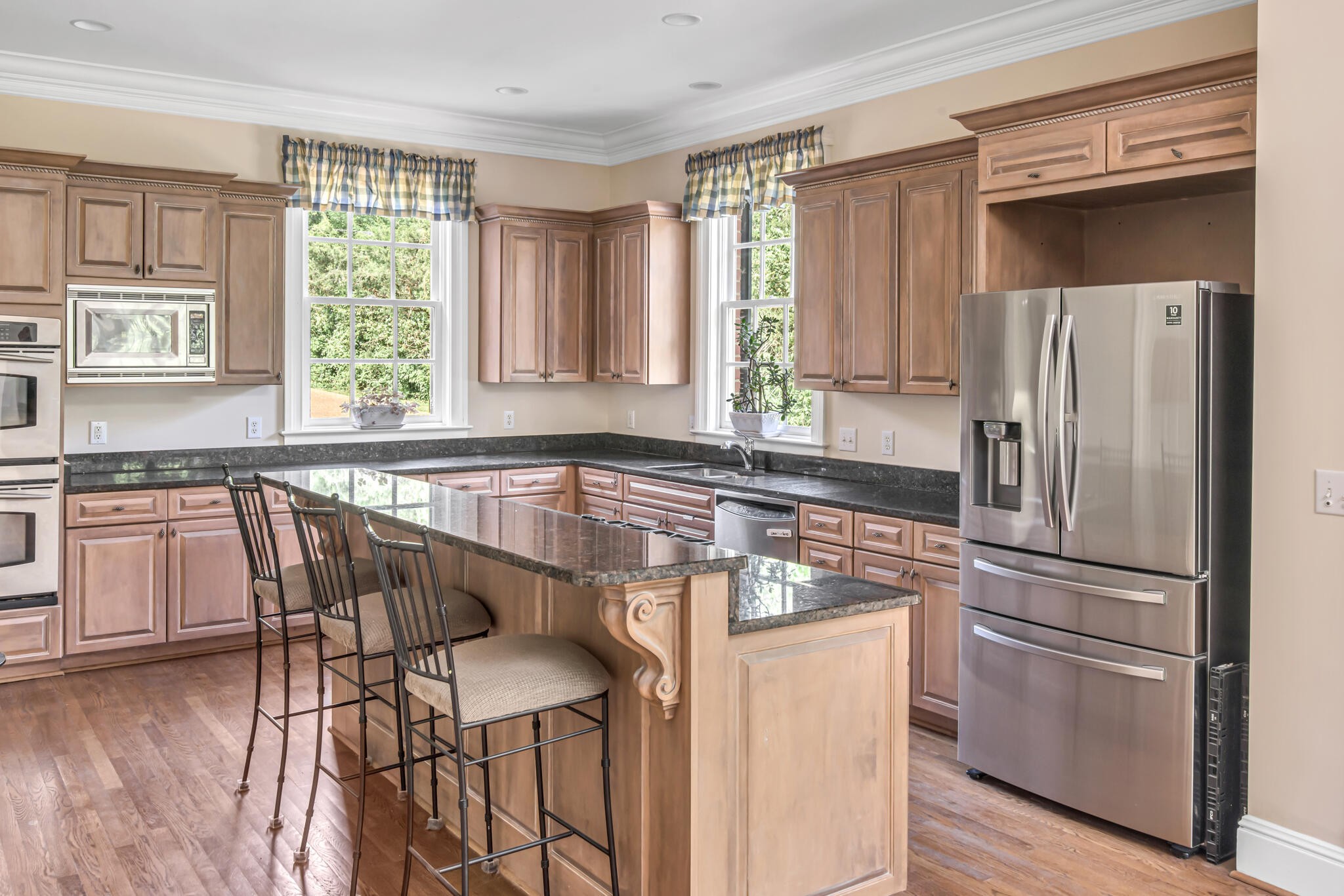 3705 Trimble Road Nashville, TN 37215 - Photo 18 of 42 a kitchen with stainless steel appliances granite countertop a refrigerator a stove a sink and white cabinets with wooden floor