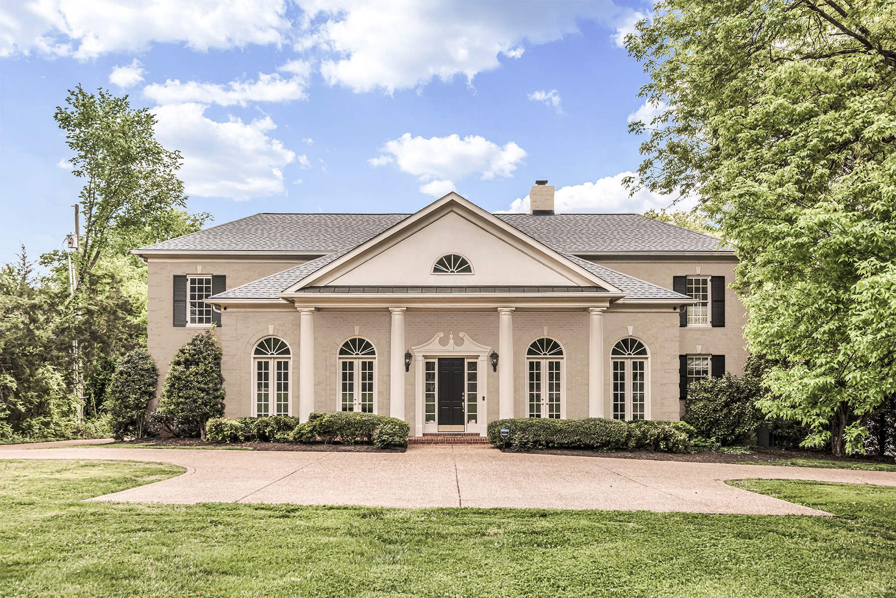 3705 Trimble Road Nashville, TN 37215 - Photo 2 of 42 a view of a white house with a yard and large trees