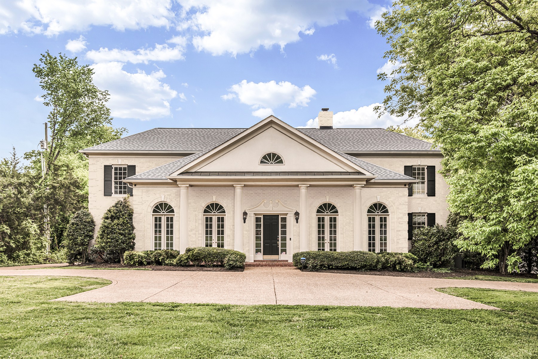 3705 Trimble Road Nashville, TN 37215 - Photo 3 of 42 a view of a white house with a yard and large trees