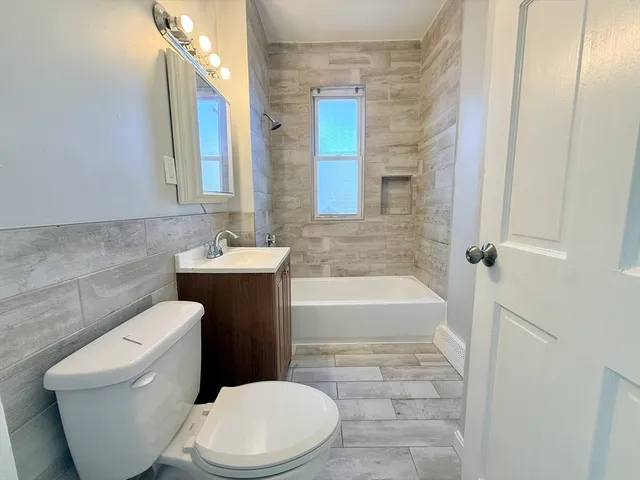 a bathroom with a toilet a sink and bathtub