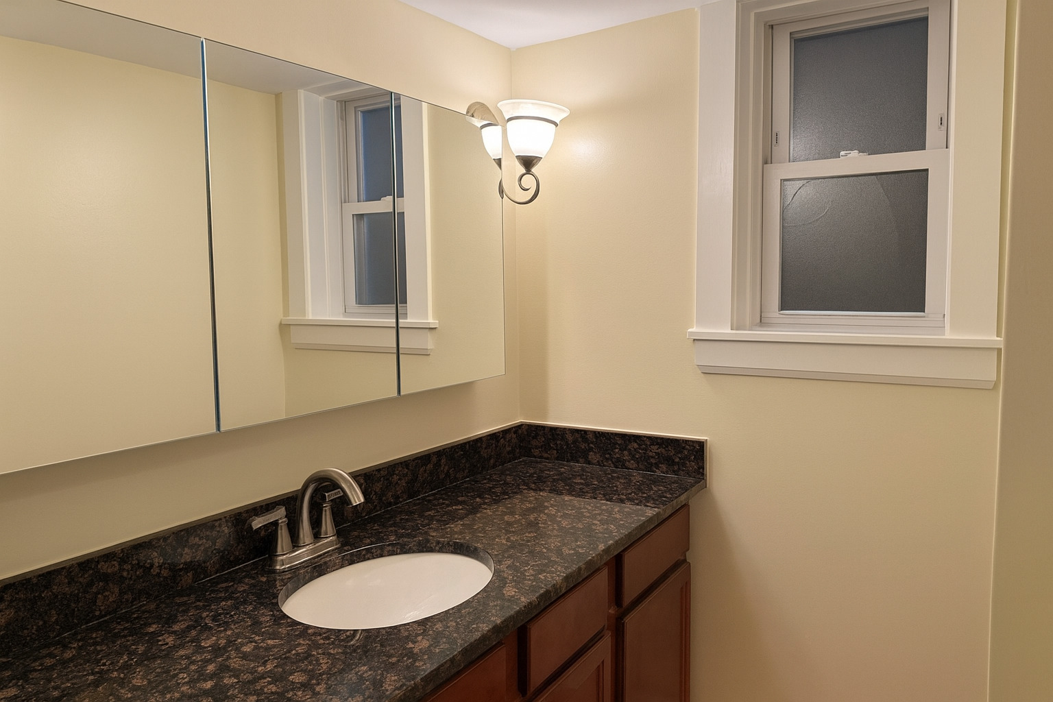 207 West Quincy Street, Unit GARD Riverside, IL 60546 - Photo 12 of 15 a bathroom with a granite countertop sink and a mirror