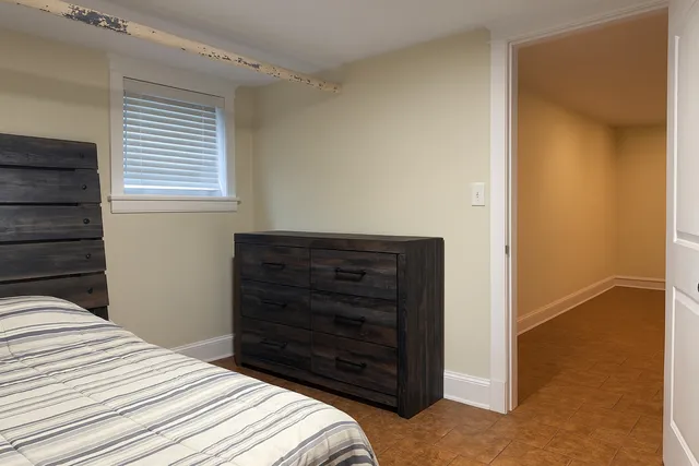 a bedroom with a bed and a dresser