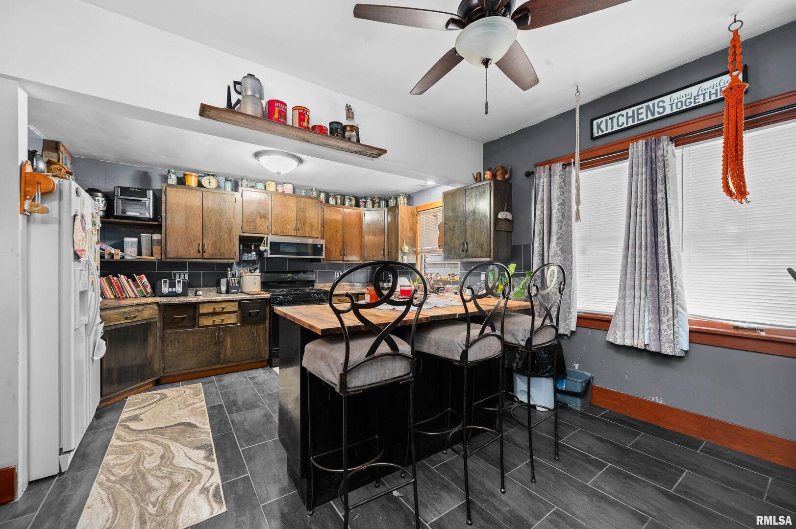 415 Southwest 4th Avenue Galva, IL 61434 - Photo 16 of 38 a kitchen with stainless steel appliances kitchen island granite countertop a table and chairs in it