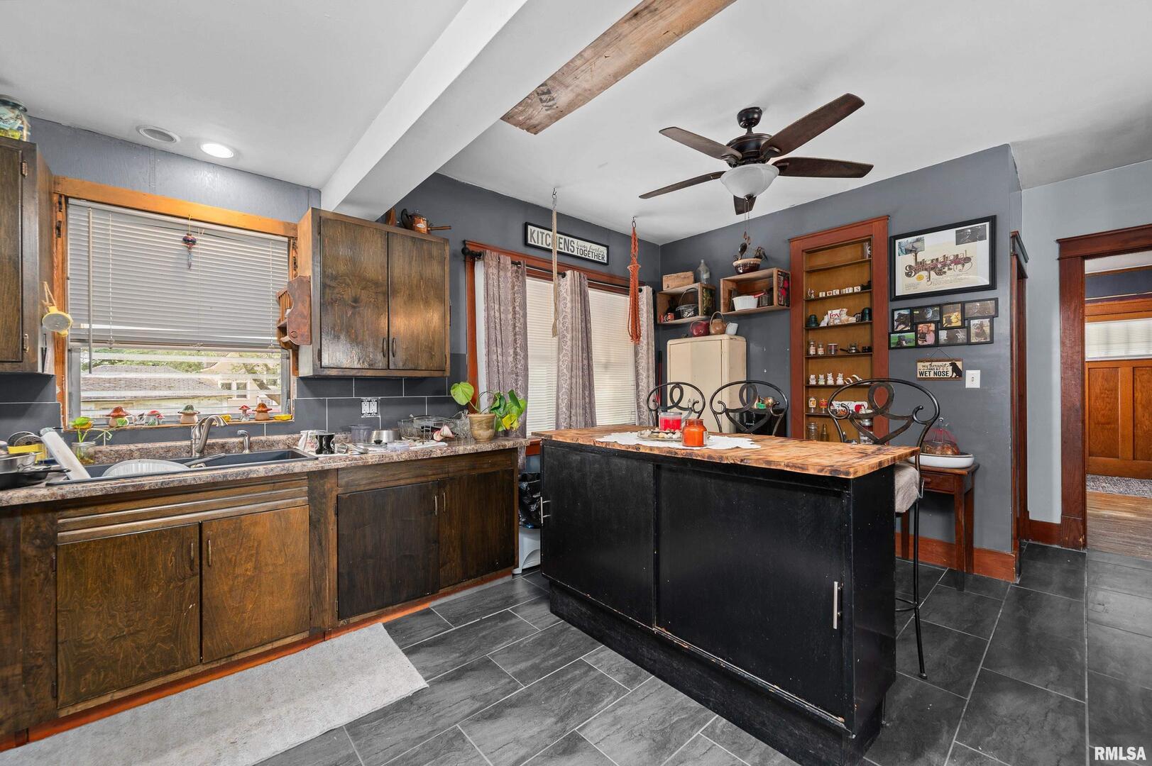 415 Southwest 4th Avenue Galva, IL 61434 - Photo 18 of 38 a kitchen with stainless steel appliances granite countertop a sink a stove and a refrigerator