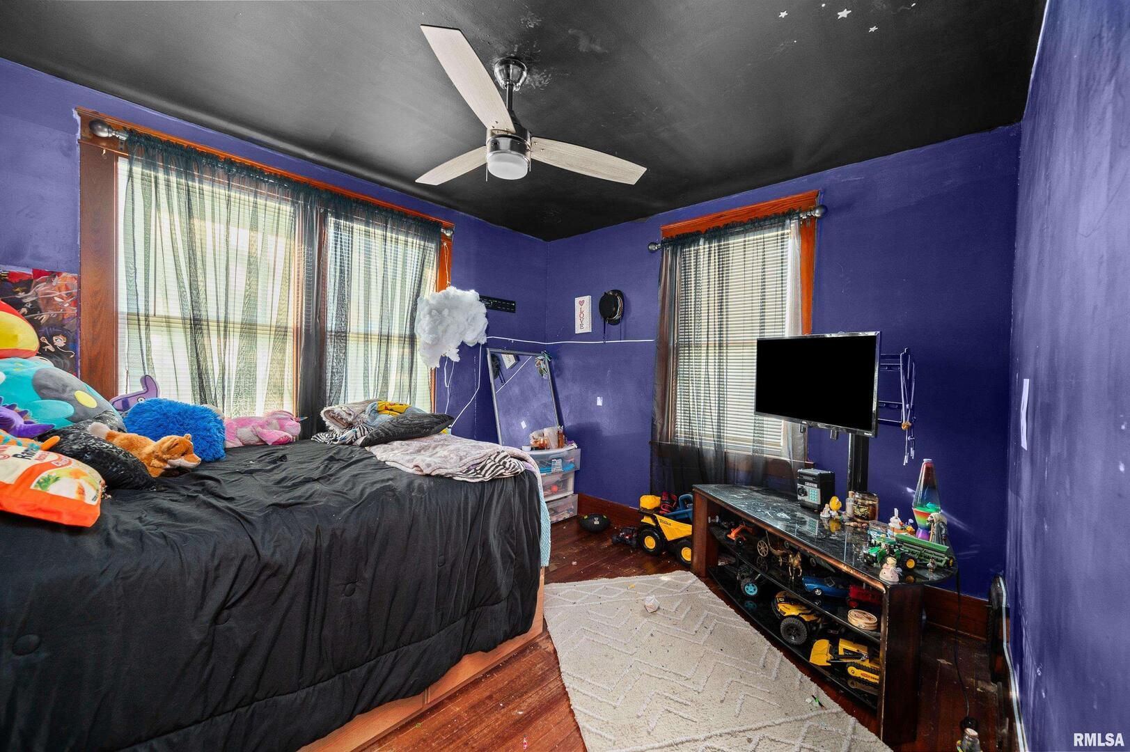 415 Southwest 4th Avenue Galva, IL 61434 - Photo 34 of 38 a bed room with furniture and a flat screen tv