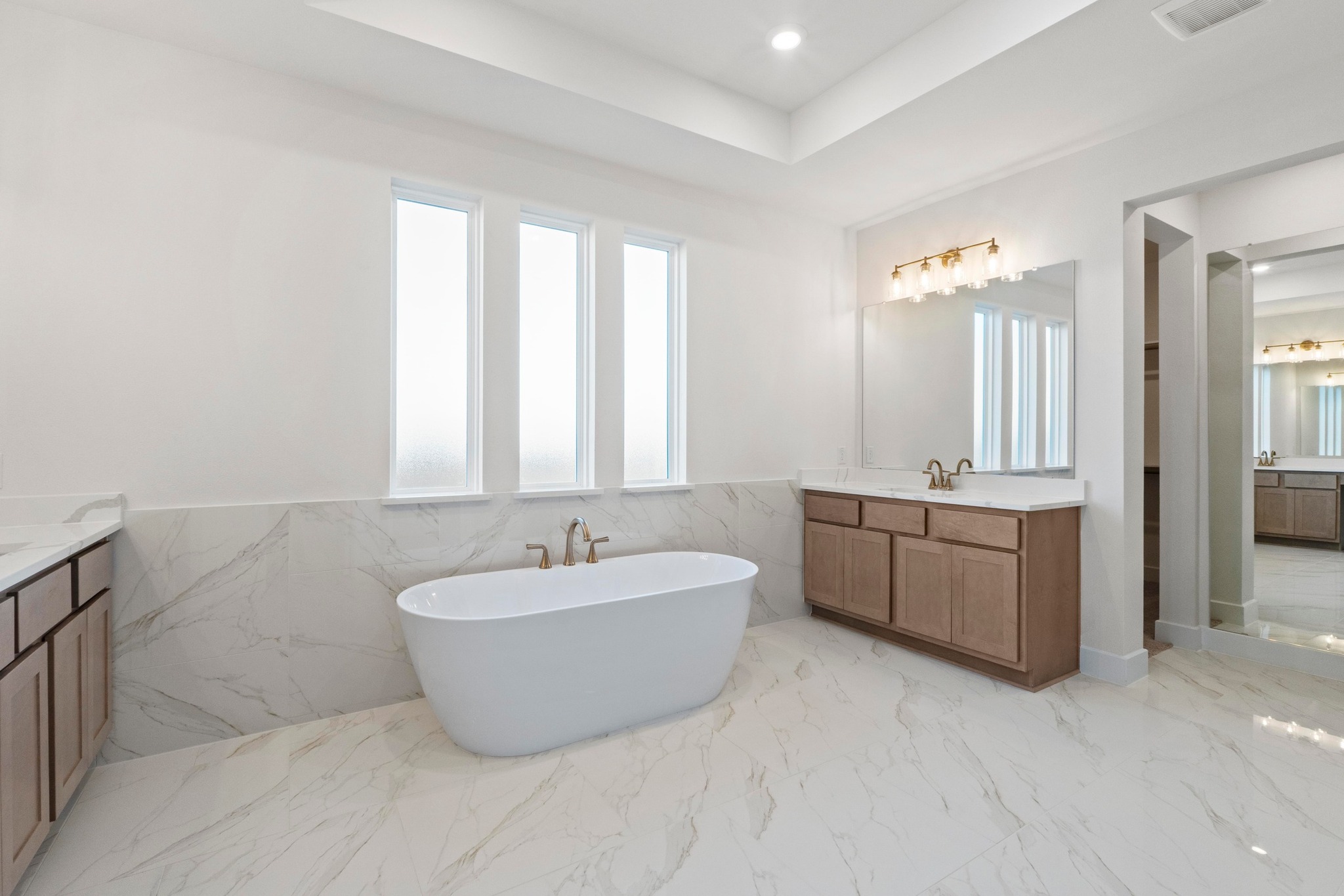 604 Lightstone Drive Georgetown, TX 78633 - Photo 12 of 39 a spacious bathroom with a double vanity sink bathtub mirror and double