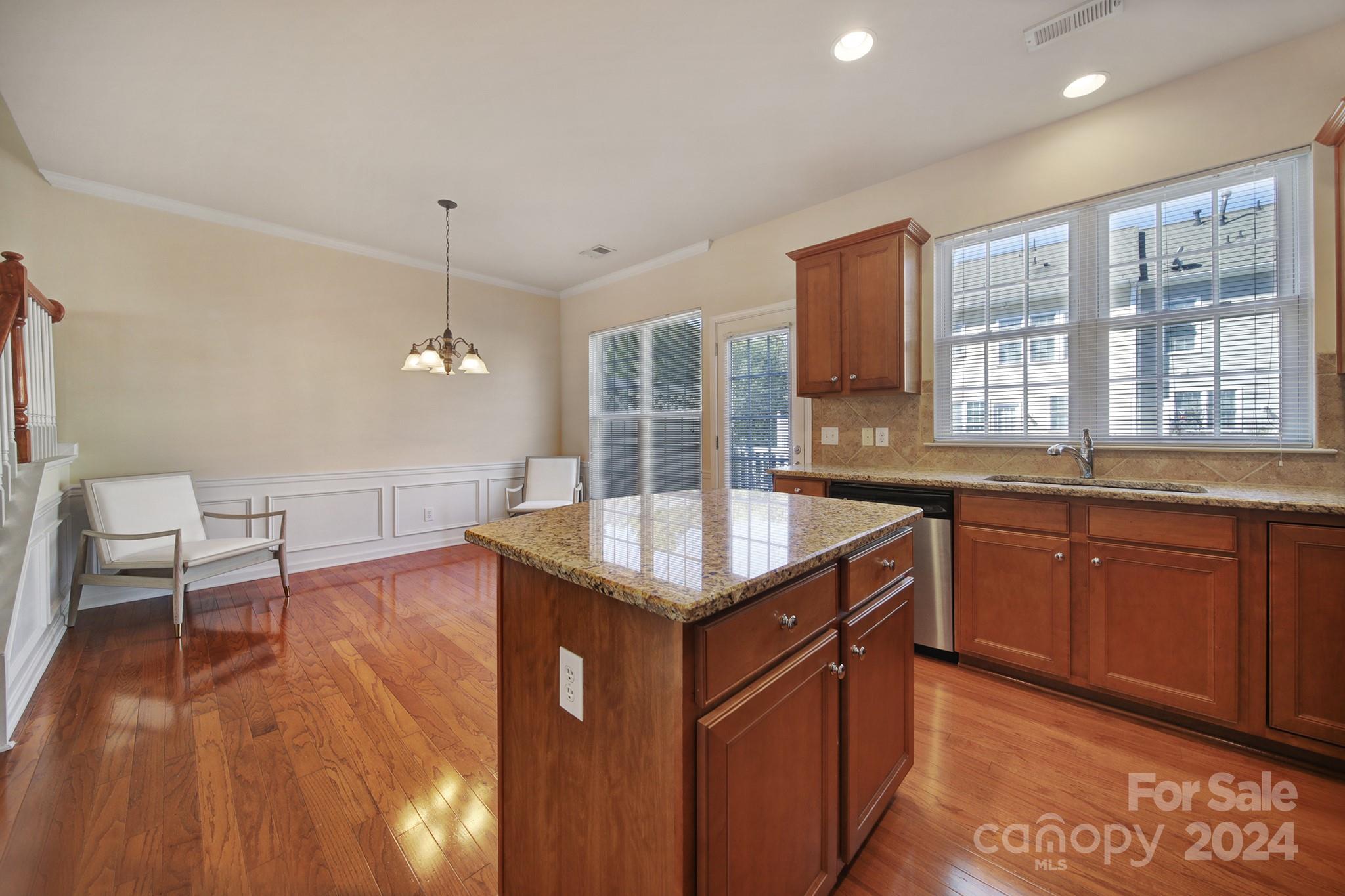 807 Granby Drive Fort Mill, SC 29708 - Photo 13 of 33 a kitchen with granite countertop sink stove and wooden cabinets