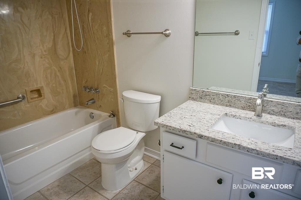 4377 Fathbrook Lane Mobile, AL 36693 - Photo 12 of 19 Full bath featuring toilet, tile patterned flooring, vanity, and washtub / shower combination