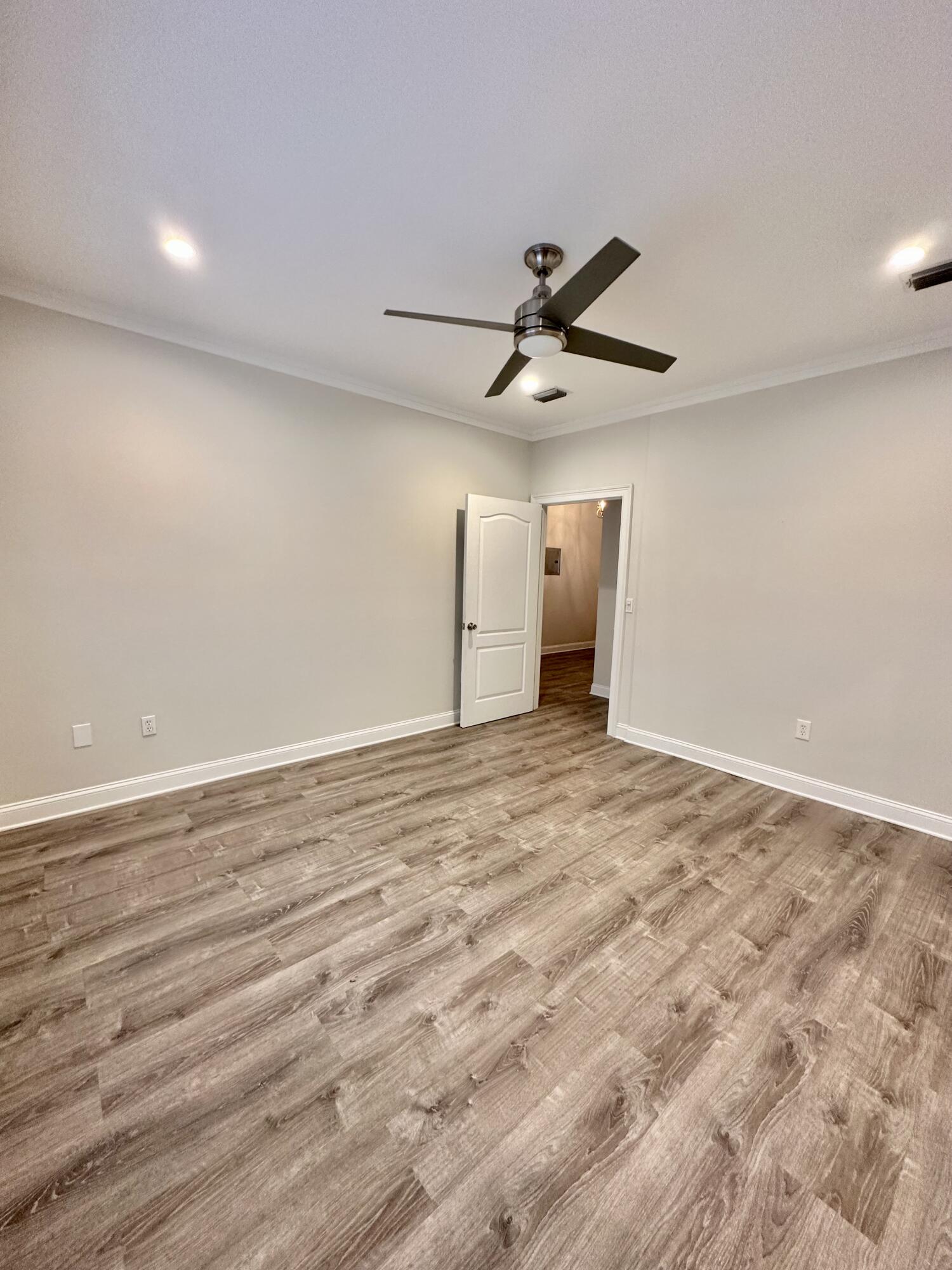 49 Wish Lane Santa Rosa Beach, FL 32459 - Photo 11 of 26 en empty room with wooden floor and ceiling fan