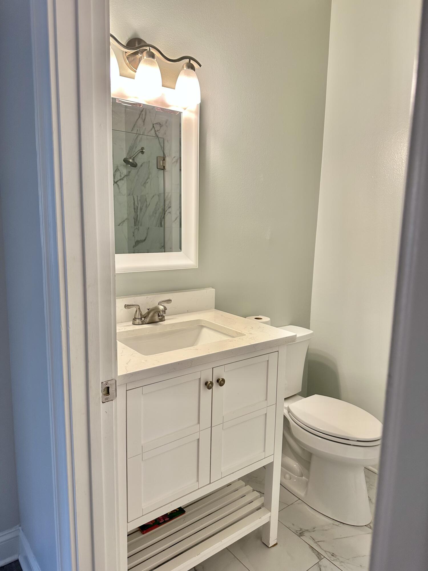 49 Wish Lane Santa Rosa Beach, FL 32459 - Photo 16 of 26 a bathroom with a sink a toilet and mirror