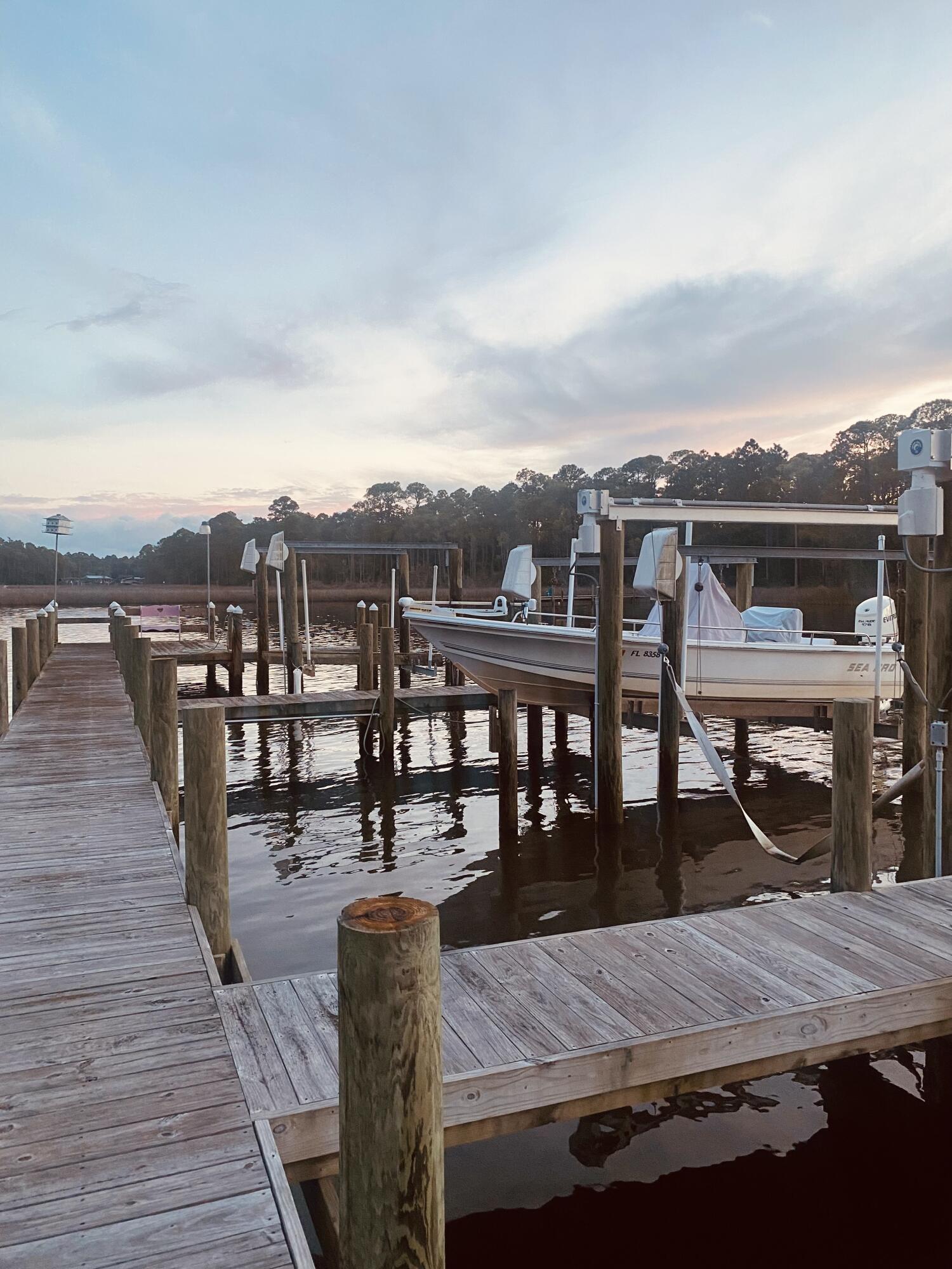 49 Wish Lane Santa Rosa Beach, FL 32459 - Photo 21 of 26 a view of a roof deck with dining table and chairs