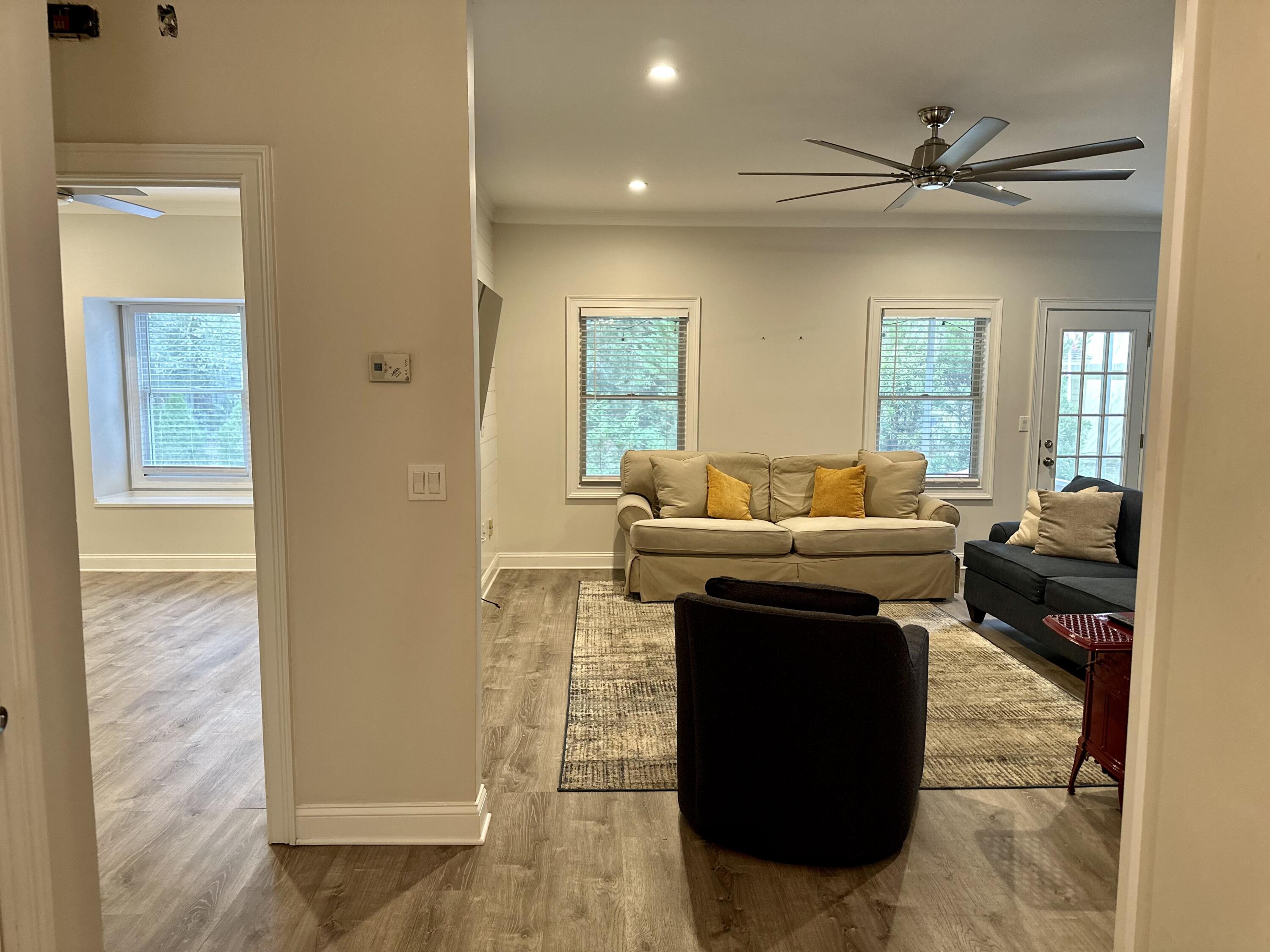 49 Wish Lane Santa Rosa Beach, FL 32459 - Photo 6 of 26 a living room with a couch and a potted plant with wooden floor