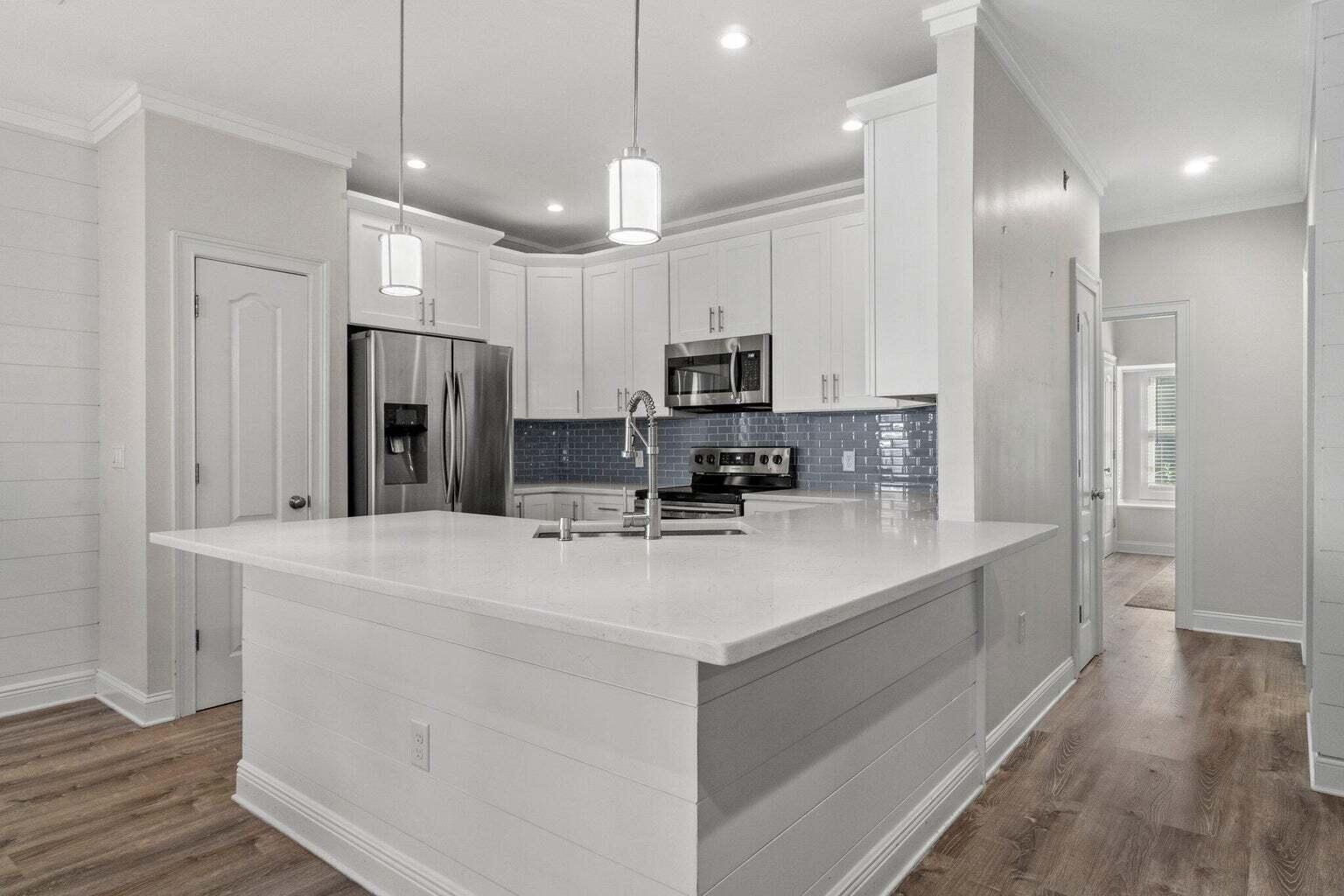 49 Wish Lane Santa Rosa Beach, FL 32459 - Photo 8 of 26 a kitchen with kitchen island a refrigerator sink and cabinets