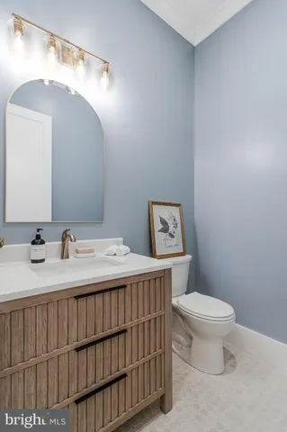a living room with furniture and large wooden floor