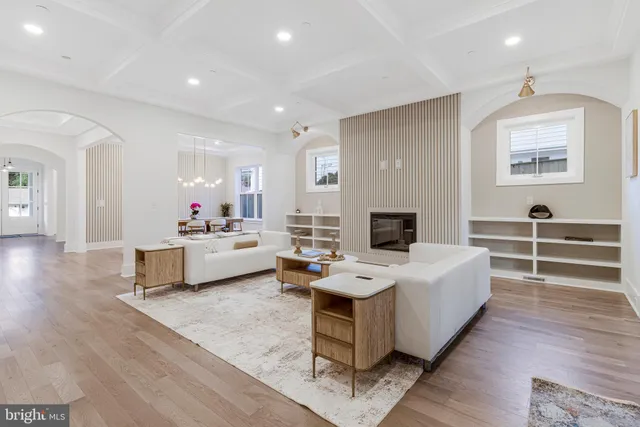 a kitchen with stainless steel appliances granite countertop a sink a stove and a wooden floors