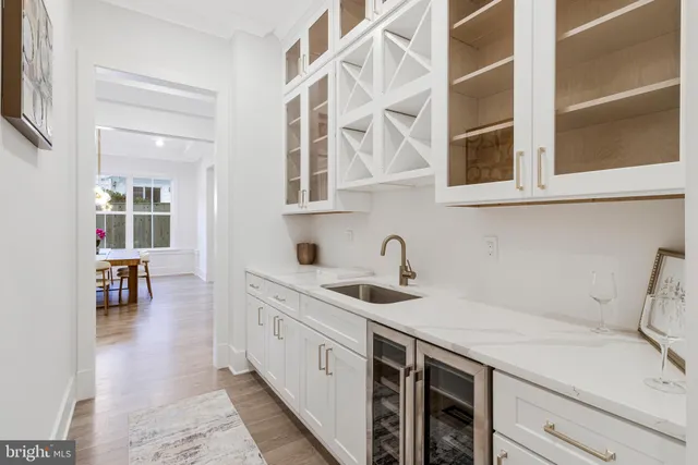 a kitchen with white cabinets and white appliances