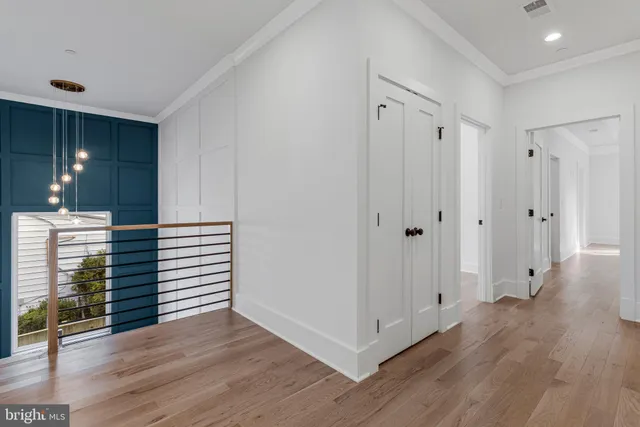 a dining room with furniture a chandelier and wooden floor