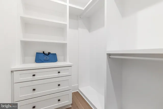 a front view of a house with a garden and yard