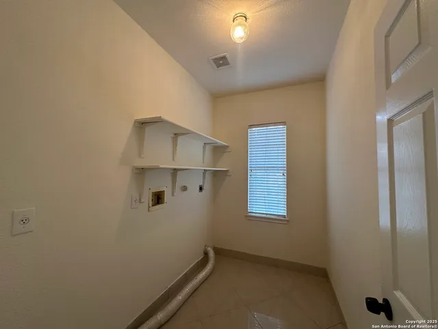 a view of a hallway with windows and stairs