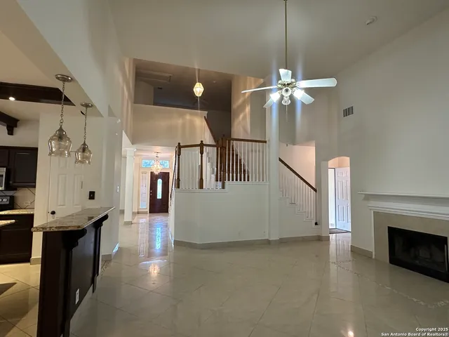 a view of a livingroom with furniture and chandelier fan